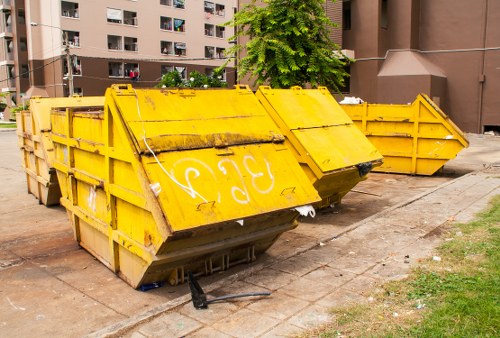 Waste collection trucks operating in West London neighborhoods